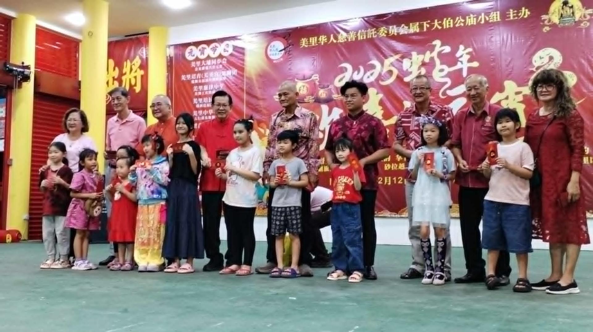 各嘉宾在美里大伯公庙元宵晚会上分发红包给出席的儿童。左4为砂交通部长拿督斯里李景胜。