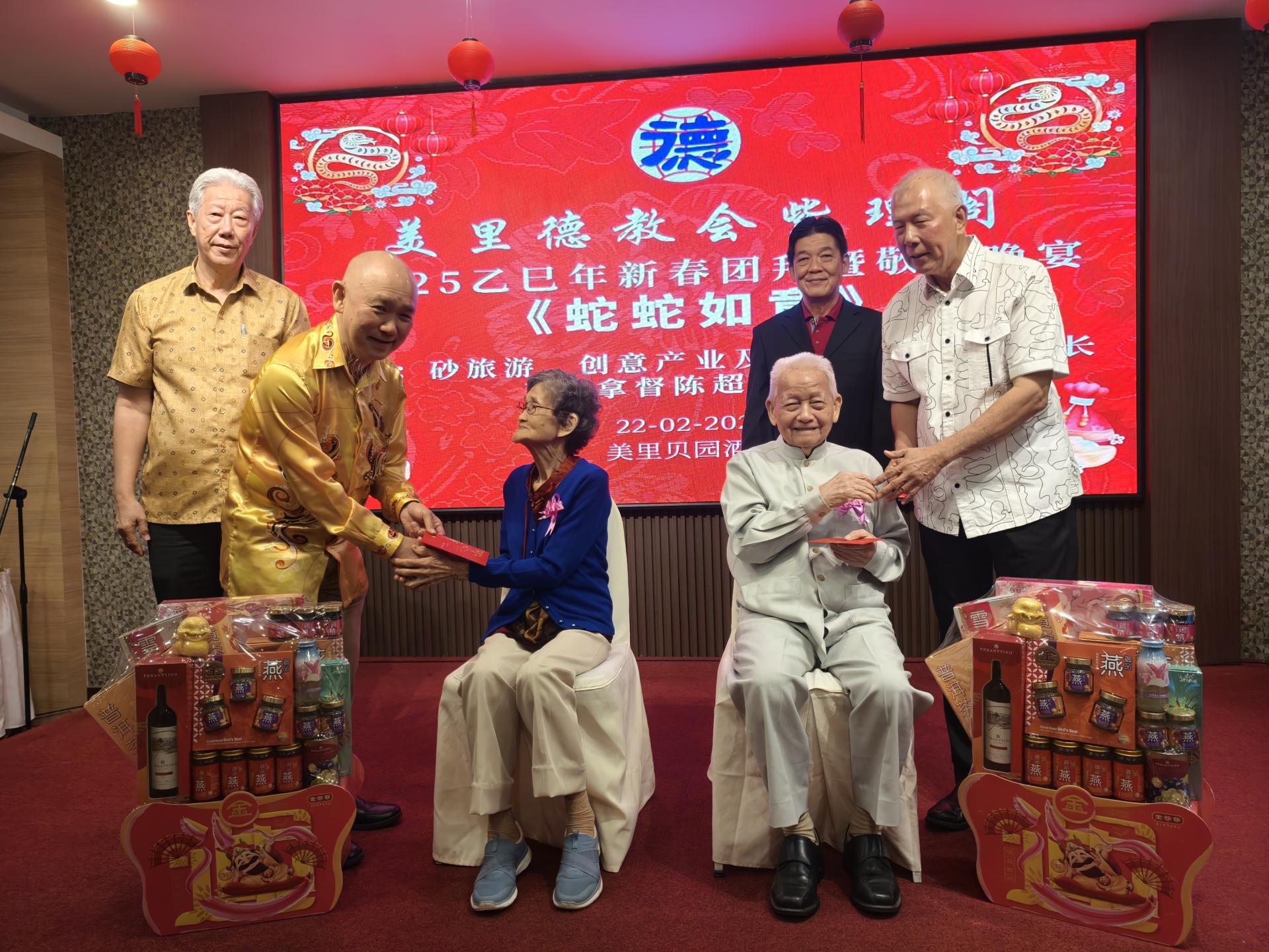 主宾拿督陈超耀(右)，紫理阁阁务顾客兼世界德教联谊总会署理总会长刘小源(左2)，在紫理阁阁长贝清湛(左1)及筹备会主席郑瑞平(右2)陪同，颁奖给最高龄男女96岁的蔡高船(前坐右者)及90岁吴新吉(前坐左者)。