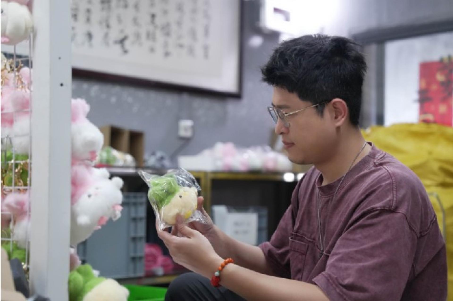 4月24日，“蒜鸟”设计师李芒果正在打包玩偶。