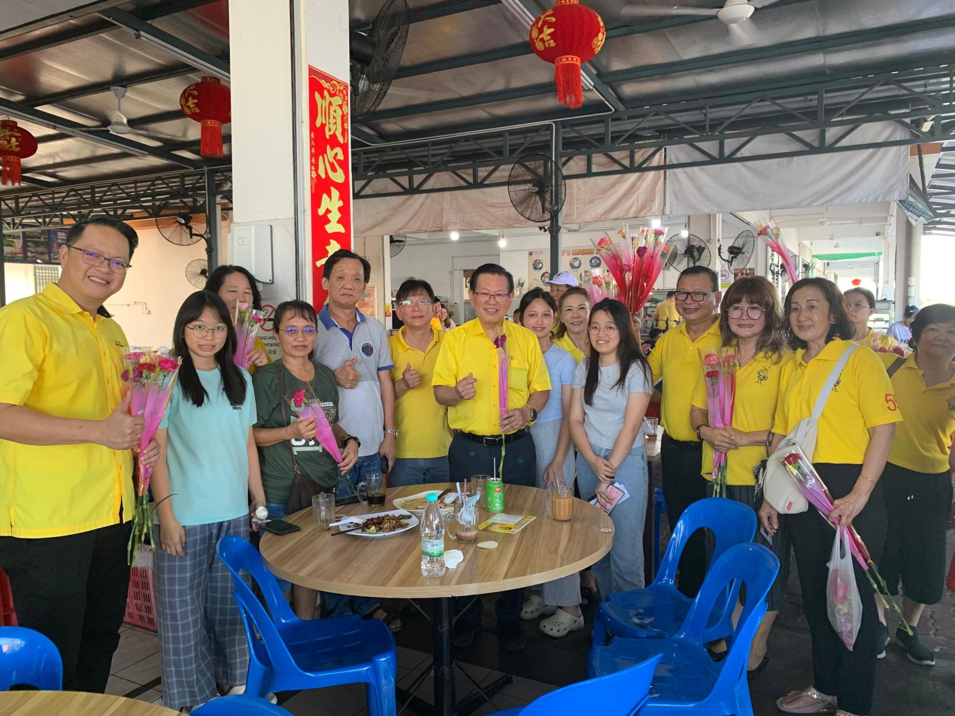 拿督斯里李景胜（前排左6）母亲节亲手献花予民众，场面温馨。左1为彭小菶。