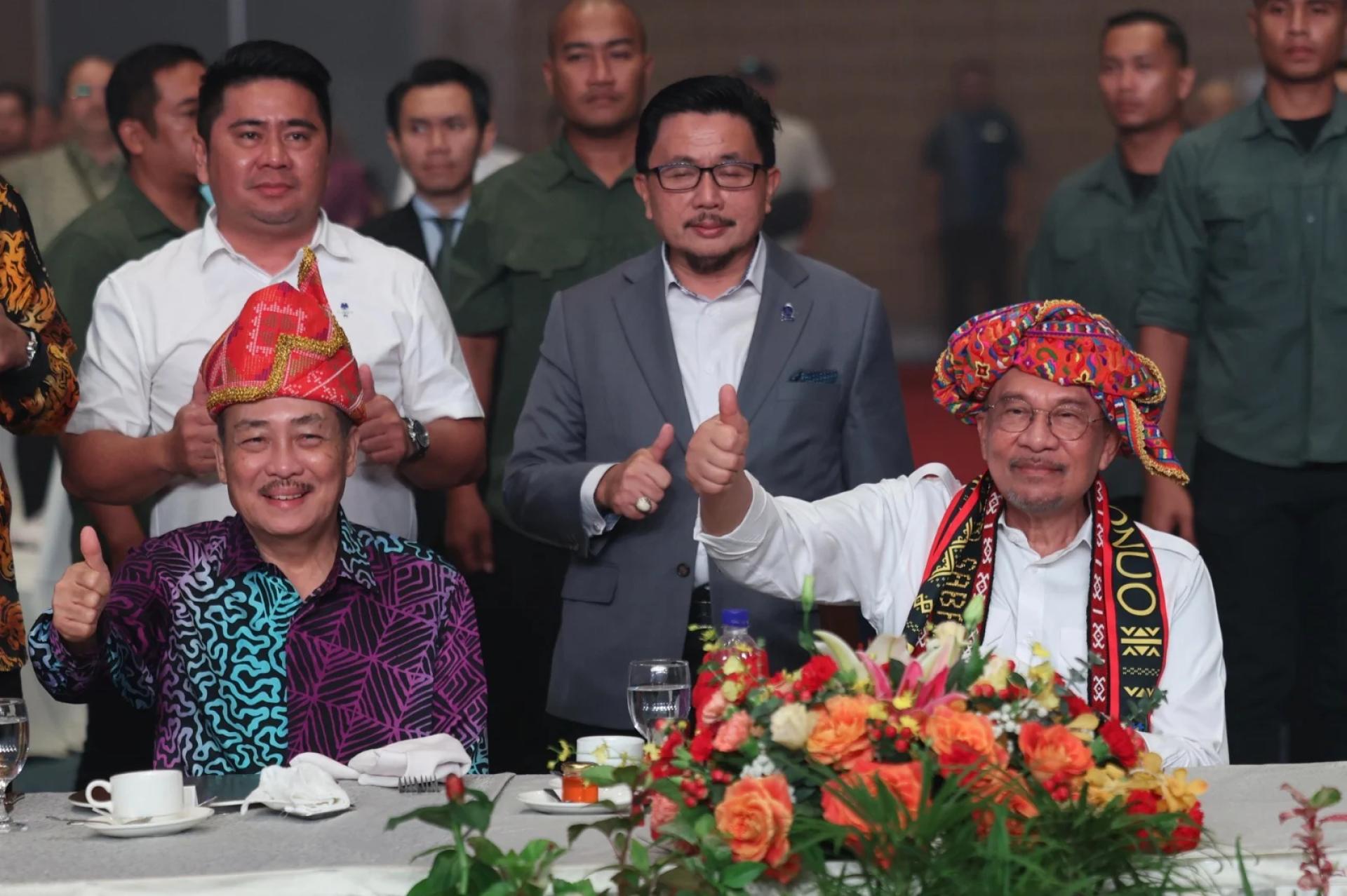 首相安华（坐者右）感谢沙巴首席部长哈芝芝（坐者左）领导的州政府，愿与联邦政府携手努力发展和提升大马和沙巴的尊严。