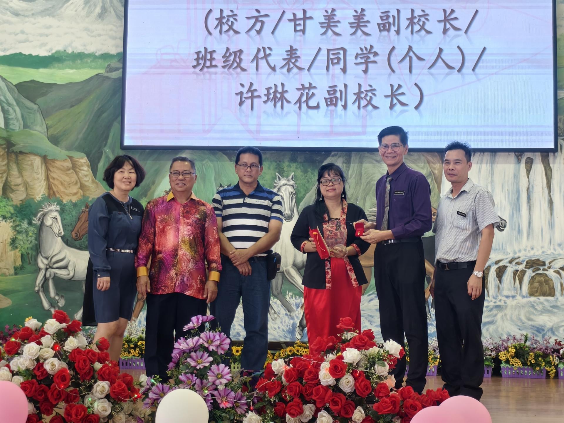 埔奕中华公学校长朱光武（右2）代表学校赠送纪念品给行政主任许琳花副校长（右3），庆祝  她荣升美里廉律中山小学担任校长。