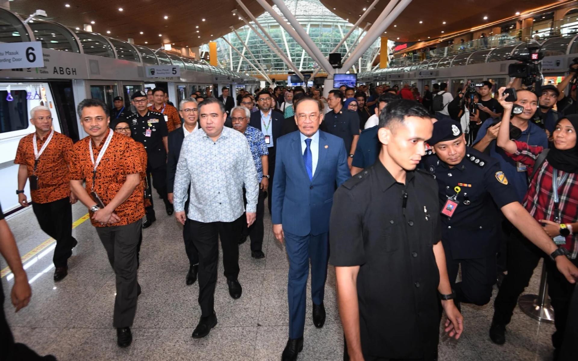 安华（左3）在陸兆福（左2）的陪同下试坐全新一代KLIA 1机场接驳电车。