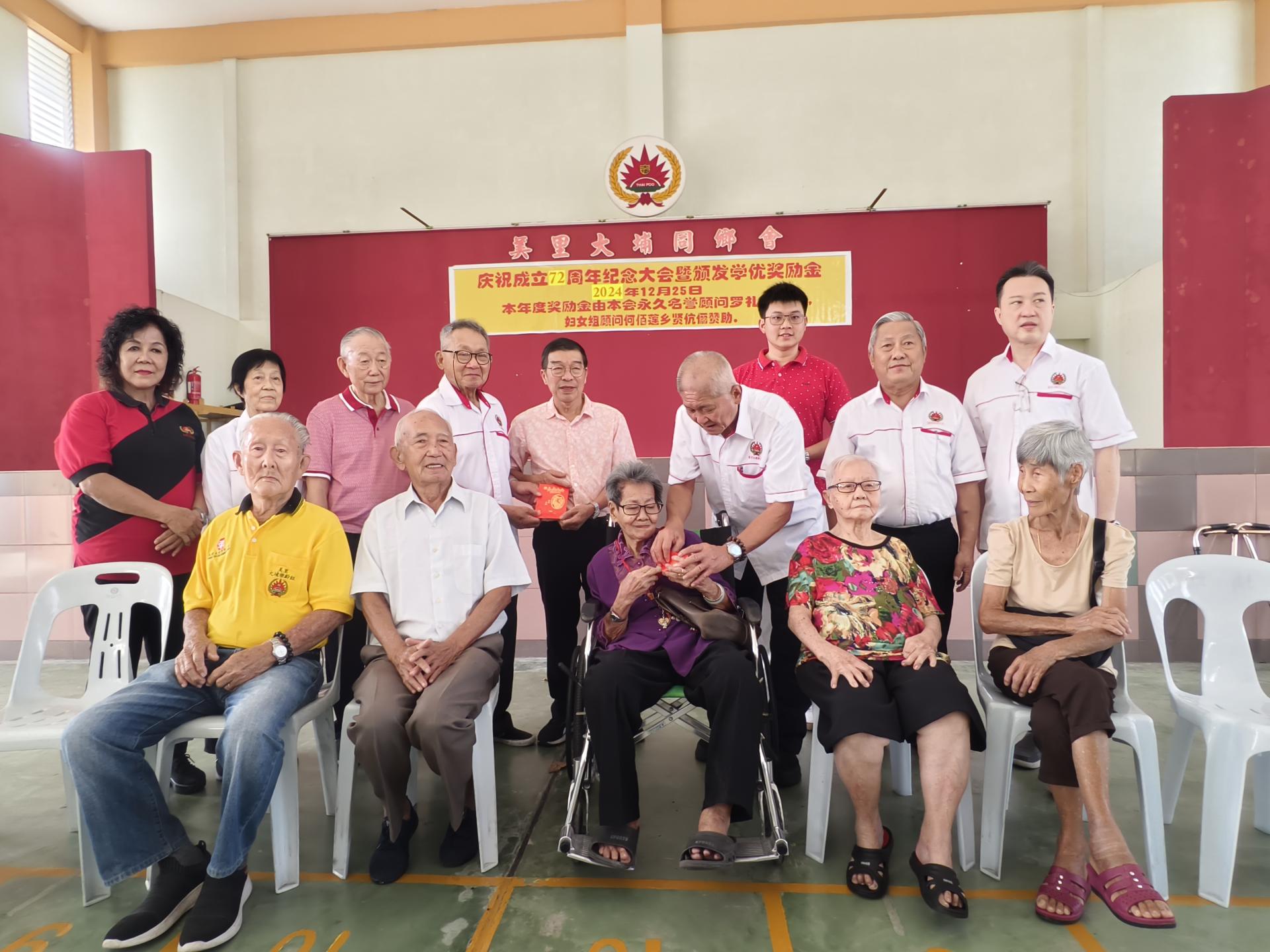美里大埔同乡会主席谢广发颁发90岁金牌及高龄同乡红仪给年长会员。