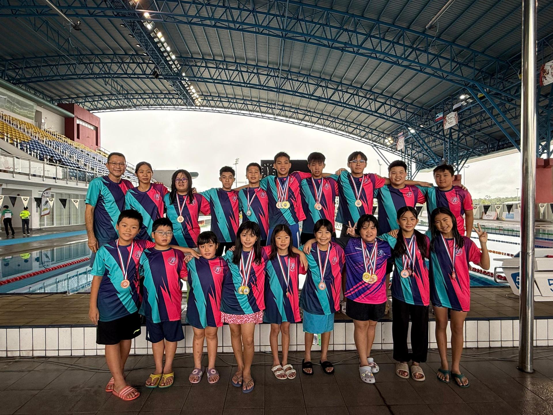 美里Top Speed Aquatic游泳俱乐部顾问兼教练钟易强（后排左1）在丹斯里拿督巴丁宜黄顺开医  生杯游泳锦标赛结束后与游泳运动员合影留念。