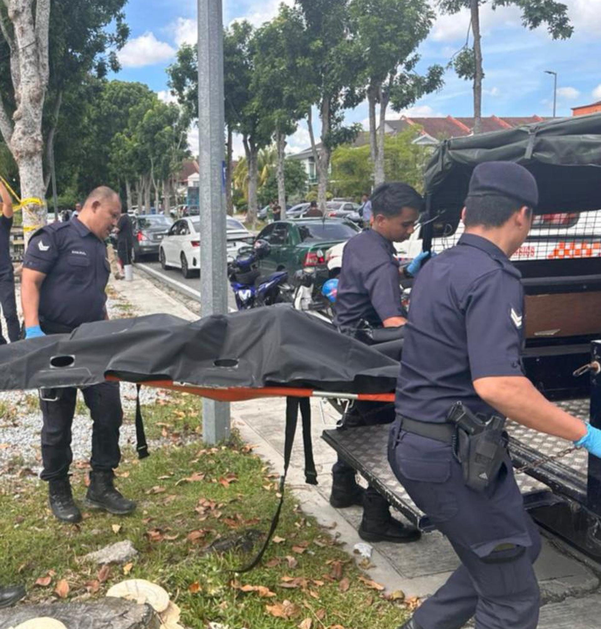 警方把死者移至警车内。