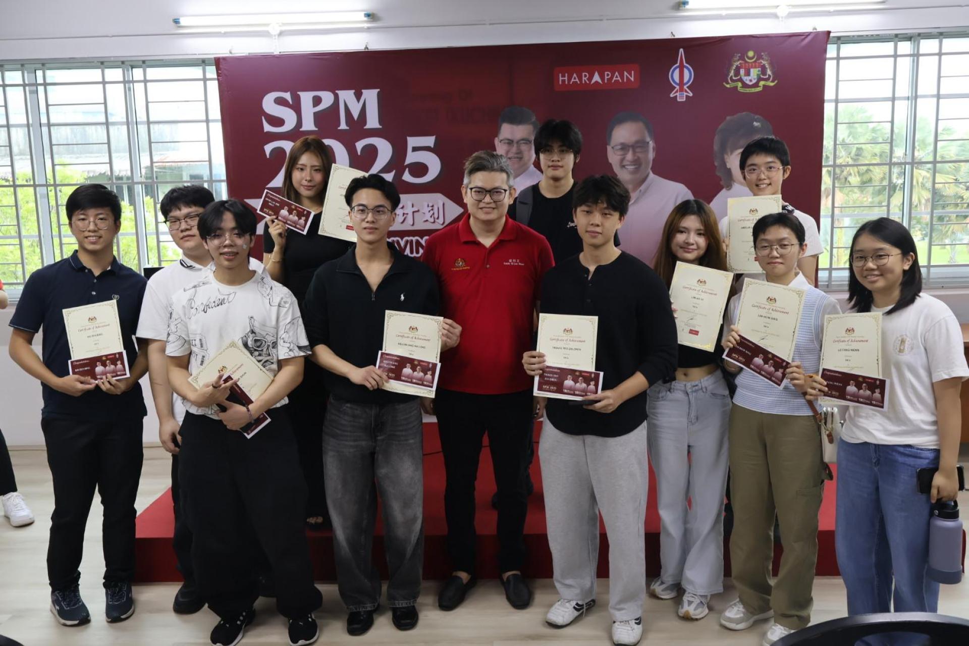 古晋市国会议员俞利文与选区上获得SPM学优奖励金的学子开心合摄。