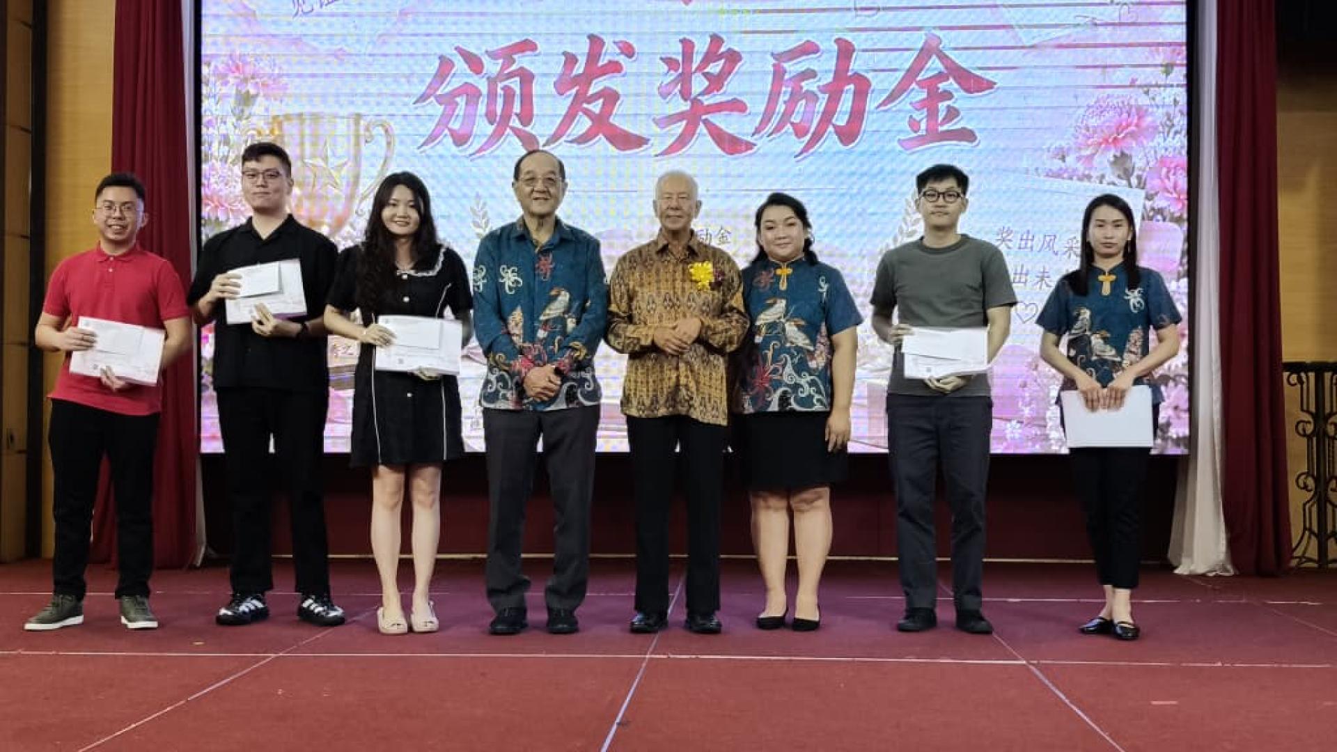 砂旅游部副部长拿督陈超耀（右4）及美里广惠肇公会会长黄运祥（左4），与荣获大学组学优奖励金的学生合影留念。