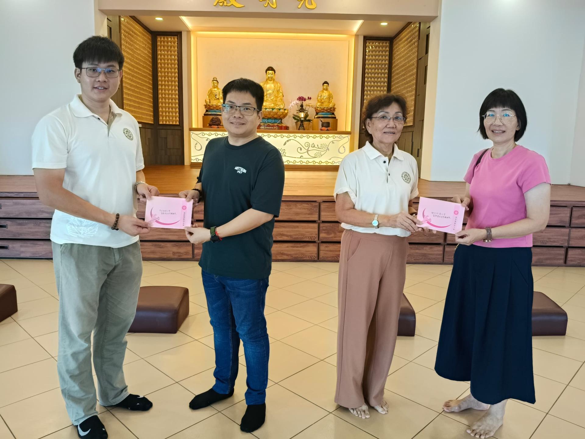美里佛教居士林副林长谢家洪（左）与财政郑美娇（右2）分别移交捐款给予美里华公政府小学校长温冠铭（左2）与美里都九小学校长刘淑慧（右）。